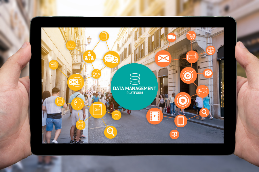 hands holding a tablet with a screenshot of a data management platform