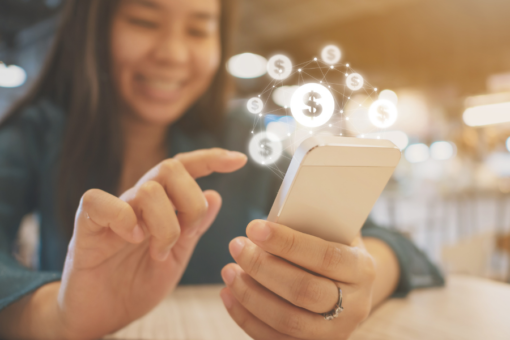 smiling woman using finance app on mobile phone